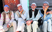 Locals wait for the results outside the counting hall in Kargil on Wednesday