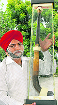 Gurdev Singh shows the legends stick, in Jalandhar