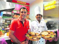 Mouth watering: Ritesh Puri (in red) with one of his chefs Photo: Manoj Mahajan