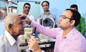 A doctor examines a patient during a medical check-up camp at the Swami Vivekanand Hospital in Ludhiana