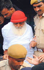 Asaram Bapu is escorted by police to a court in Jodhpur on Monday.
