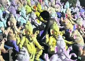 DIVINE SERVICE: An artisan gives the finishing touches to idols of Lord Ganesha ahead of Ganesh Chaturthi in Ludhiana