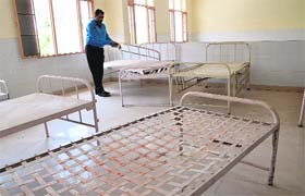 Shiv Ram Saroya, founder of an NGO, shows poorly kept beds in the burns unit