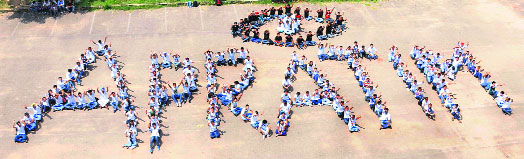 Students of the Chandigarh College of Engineering and Technology get together to spell out the name of a cultural programme, Apratim, at the Sector 26 campus in Chandigarh on Tuesday.
