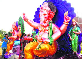 Artists give final touches to the idols of Lord Ganesha ahead of Ganesh Chaturthi on the Ambala-Chandigarh highway at Zirakpur.