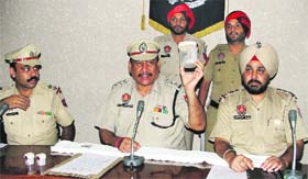 ACP Satish Malhotra shows the seized drug during a press conference