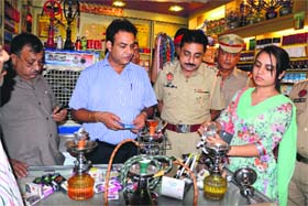 Officers of the Health and Police Departments during a raid at Chaurasia Paan Parlour on the Malhar road