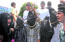 Protesters stage a mock hanging outside the Saket District Court in New Delhi on Tuesday