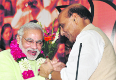 BJP national president Rajnath Singh congratulates Gujarat CM Narendra Modi after declaring him BJPs PM candidate in New Delhi on Friday.
