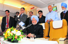 PM Manmohan Singh talks to the media during an on-board press conference on his way home from Frankfurt, on Tuesday.