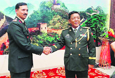 Indian and Chinese Army officers meet at a function to mark the 64th Chinese National Day near Chushul town on the Chinese side on Tuesday.
