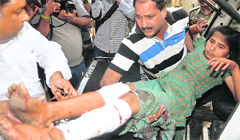 A minor girl hurt in firing being shifted to a hospital in Jammu on Thursday. Tribune photo