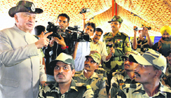 Union Home Minister Sushilkumar Shinde interacts with BSF men in Samba on Tuesday.  PTI 