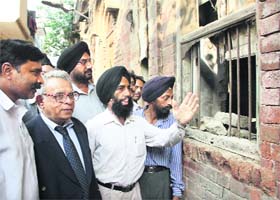 Former acting President of Pakistan, Wasim Sajjad (second from left), looks at his ancestral house at Suraj Ganj locality near Jyoti Chowk in Jalandhar