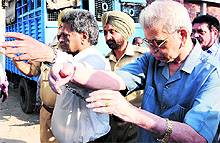 Dr OP Mahajan (R), former principal, Government Medical College, being taken to jail in Amritsar on Saturday