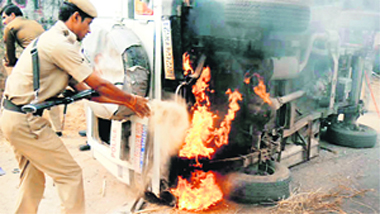 A police vehicle set on fire by a mob following the death of two students on the Sohna-Palwal road on Wednesday