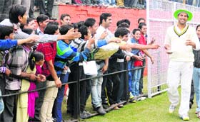 Fans of Yuvraj Singh try to shake hands and seek his autograph during a Ranji Trophy match at the Cricket Stadium, Sector 16, in Chandigarh on Thursday