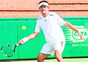 A player returns a shot during the 14th All-India Police Lawn Tennis Championship held at the CLTA, Sector 10, Chandigarh
