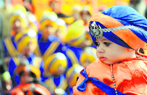 A young devotee takes part in nagar kirtan ahead of the Martyrdom Day of Guru Tegh Bahadur in Ludhiana on Friday.