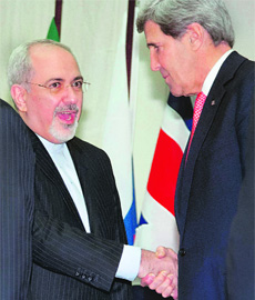 US Secretary of State John Kerry (R) shakes hands with Iranian Foreign Minister Mohammad Javad Zarif after the deal in Geneva on Sunday. 