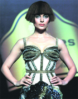 Bollywood Actress Kangana Ranaut displays designer Gaviin Miguel's creation during a fashion show, in Mumbai.