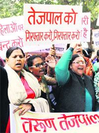 Women activists protest against Tarun Tejpal in New Delhi.