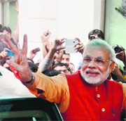 BJP's PM candidate Narendra Modi arrives at the BJP headquarters in New Delhi on Sunday.