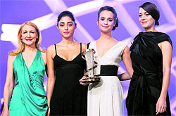 Jury members, US actress Patricia Clarkson (left) Iranian actress Golshifteh Farahani (second from left) and French actress Marion Cotillard (right) pose for photographers with Swedish actress Alicia Vikander as she holds her best actress award for the film Hotell during the 13th Marrakech International Film in Marrakech