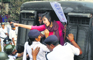 Kolkata Police detain a student during a march to the US Consulate in protest against the Indian diplomats arrest. 