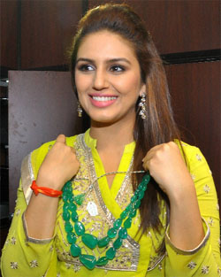 Bollywood Actress Huma Qureshi trying out jewellery on day 2 of the four-day 11th Jaipur Jeweller Show in Jaipur.