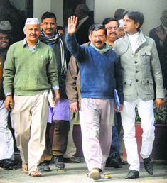 AAP chief Arvind Kejriwal (C) with other party leaders Manish Sisodia (L) and Kumar Vishwas (R) after meeting the Lt Governor in New Delhi on Monday.
