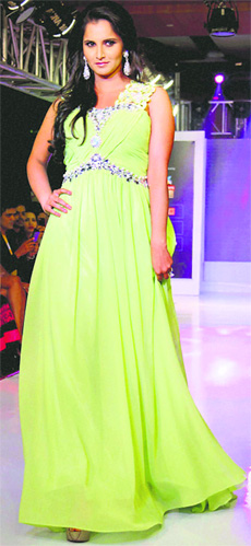 Indian tennis ace Sania Mirza walks the ramp for designer Shivali Singh on the fourth day of the Hyderabad International Fashion Week, in Hyderabad on Sunday.