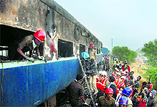 Rescue operations under way after an AC coach of the Bangalore-Nanded Express caught fire in Anantapur on Saturday
