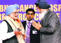 Punjab CM Parkash Singh Badal presents a sword to