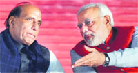 BJP chief Rajnath Singh with partys PM nominee Narendra Modi at the National Council meeting in New Delhi on Saturday. tribune Photo