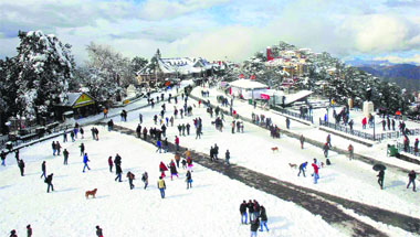 Tourists and locals throng the Ridge after fresh snowfall on Saturday. Shimla received seasons heaviest snowfall with the entire town donning a white mantle. Photo: Amit Kanwar