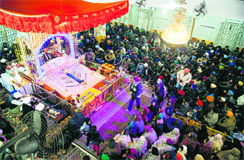 Sikh devotees pay obeisance at a gurdwara on the occasion of the birth anniversary of Guru Gobind Singh.