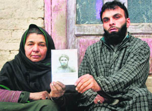  A family holds the picture of one of the victims killed in the encounter. 