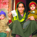 A woman holds the photo of her family member killed in the Pathribal encounter in 2000.