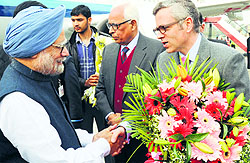 Chief Minister Omar Abdullah receives Prime Minister Manmohan Singh at Jammu airport. Governor NN Vohra also seen in the picture