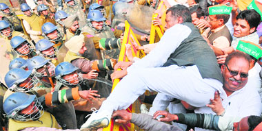 BJP Kisan Morcha activists try to break a police barricade at the Karnal railway station during the rail roko agitation on Friday. Tribune photo: Ravi Kumar