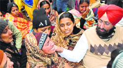 PPCC president Partap Singh Bajwa consoles Kiranjit Kaur, mother of the deceased child, in Bathinda on Friday. photo: Pawan Sharma