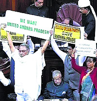 Members opposing Andhras bifurcation hold placards in the Rajya Sabha in New Delhi on Wednesday