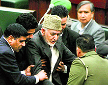 PDP MLA Syed Bashir being led out of the J-K Legislative Assembly by marshals on Wednesday