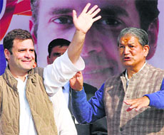 Congress V-P Rahul Gandhi with Uttarakhand Chief Minister Harish Rawat at a rally in Dehradun on Sunday.