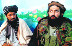 Tehreek-e-Taliban Pakistan spokesman Shahidullah Shahid (R) at a press meet at an undisclosed location.