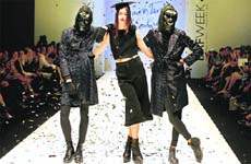 Playing hide and seek: Models, some wearing masks, wear creations from the Amores Trash Couture collection during Buenos Aires fashion week in Buenos Aires, Argentina. — Agencies