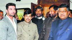 BJP leaders Ravi Shankar Prasad (R) and Shahnawaz Hussian (2L) with Lok Janshakti Party leader Ram Vilas Paswan (2R) and his son Chirag (L) in New Delhi on Thursday.