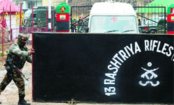 A soldier opens the gates of the Rashtriya Rifles camp for a team of medics to leave in Ganderbal district on Thursday.