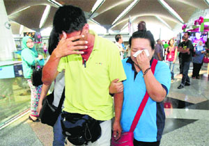 Relatives of passengers aboard the ill-fated flight at Kuala Lumpur International Airport on Saturday.